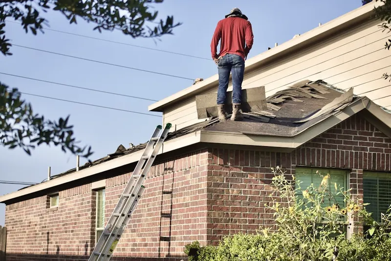 Professional roofer working on a residential roof in Globeville